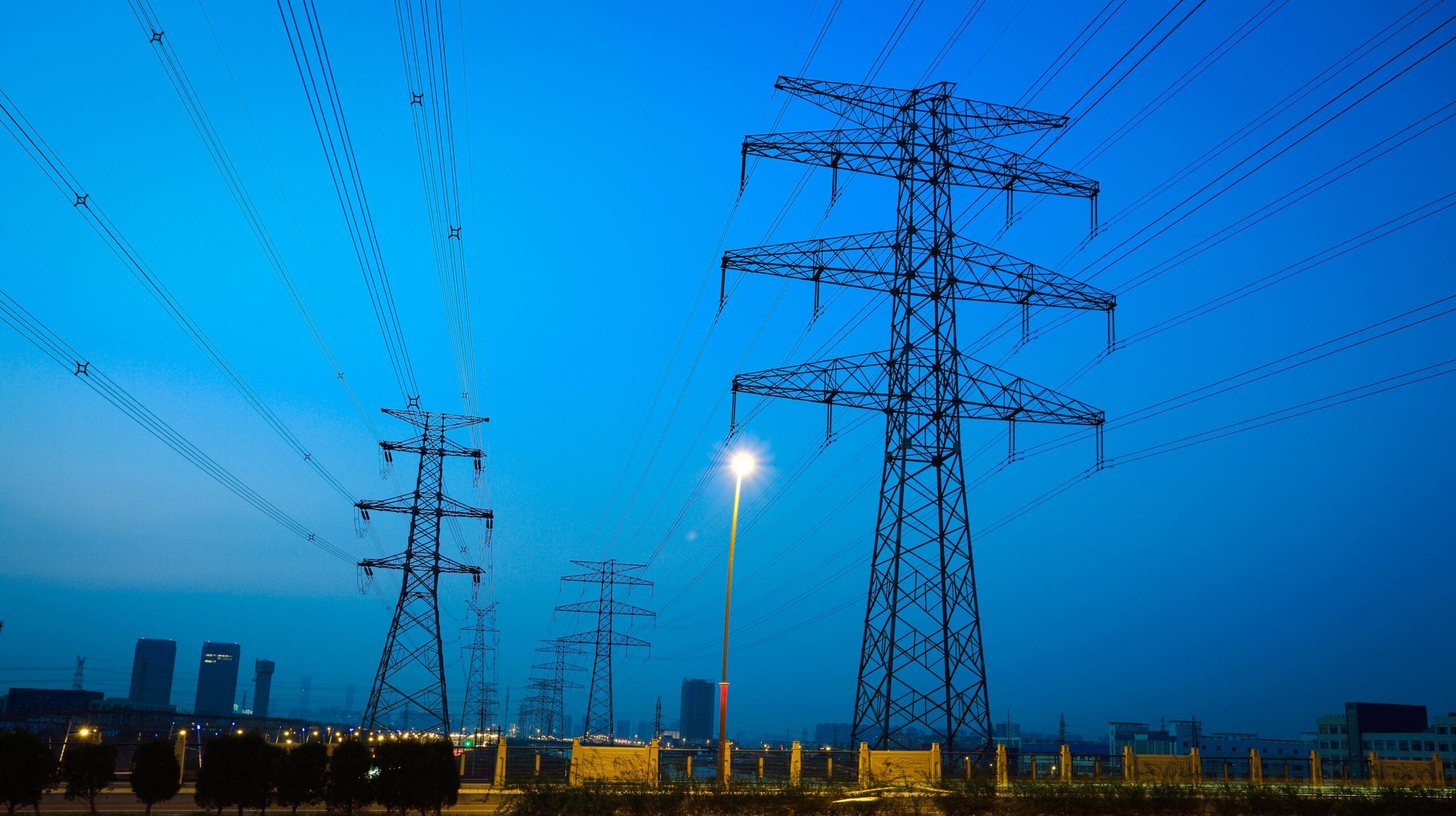 the high voltage electricity pylon in side of highway High Voltage Electricity Pylon at Night
