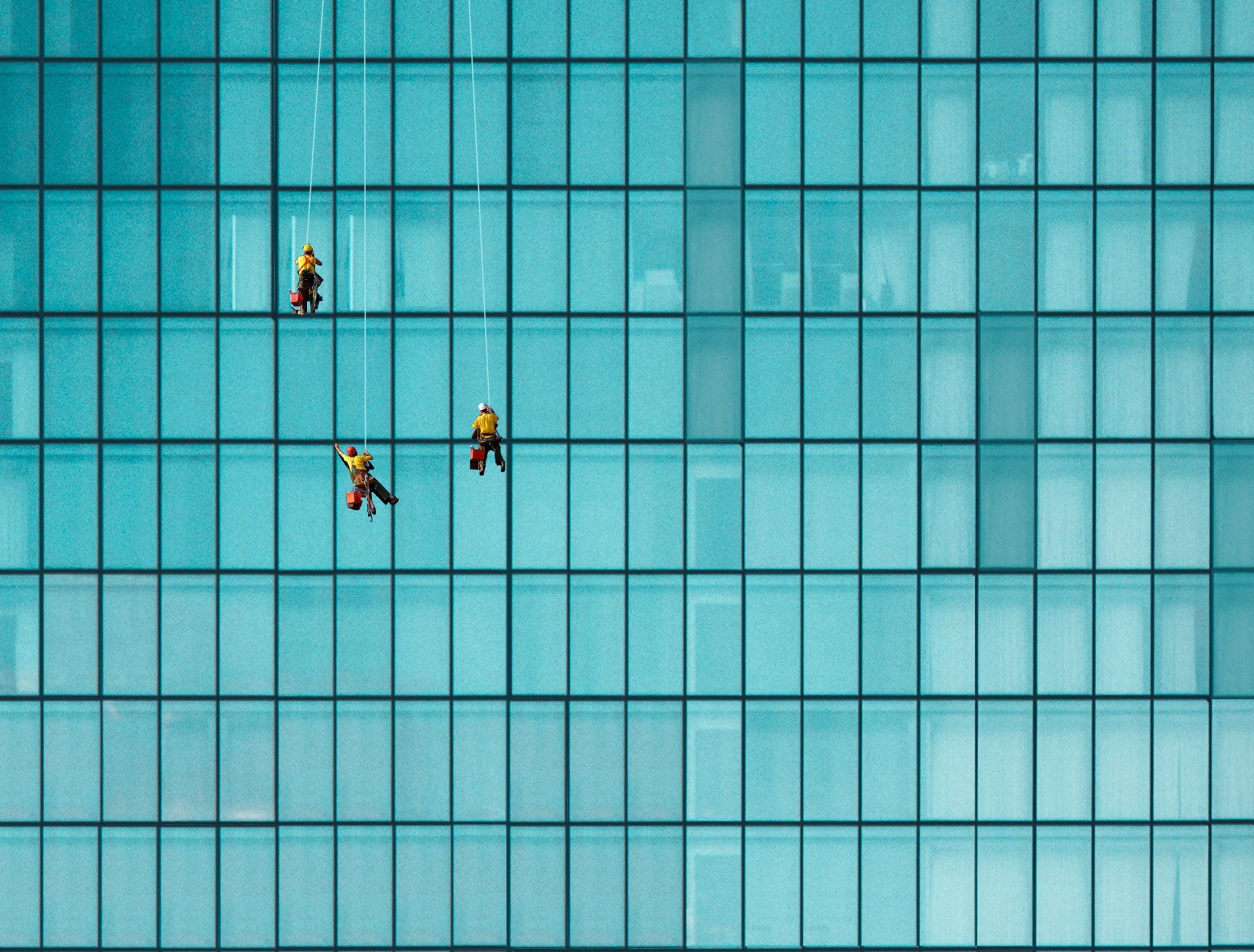 Men working on side of skyscraper