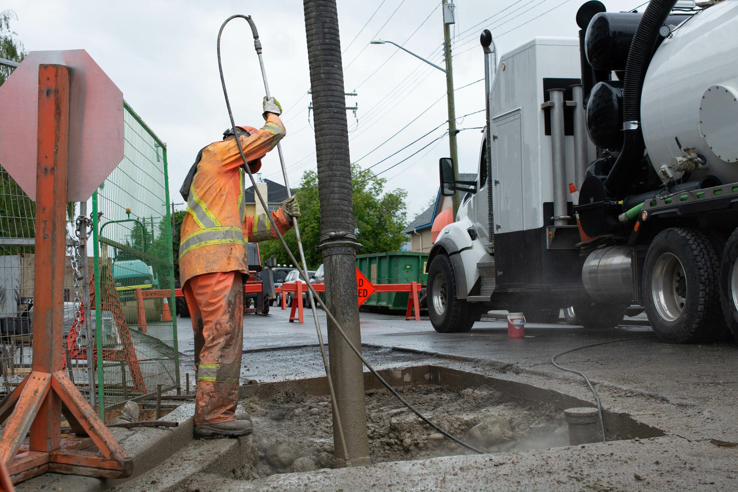 Construction worker operating a suction pipe