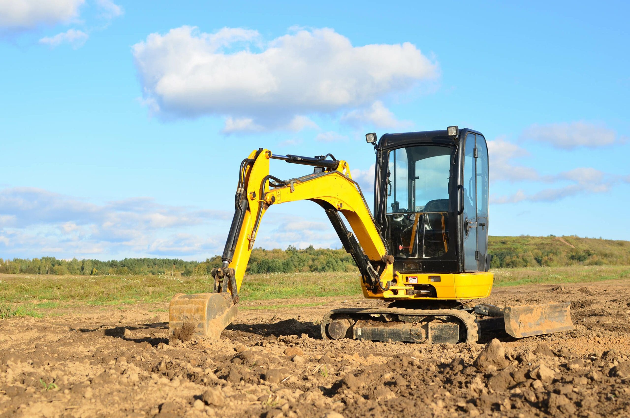 Excavator digging in a field