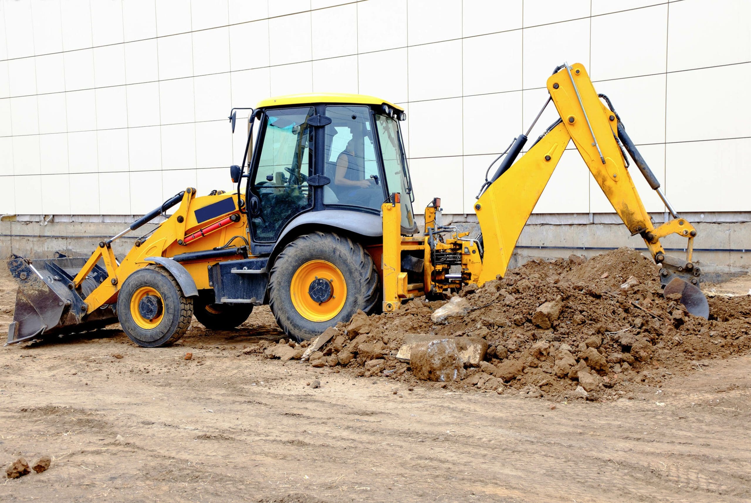 Excavator in front of an office building