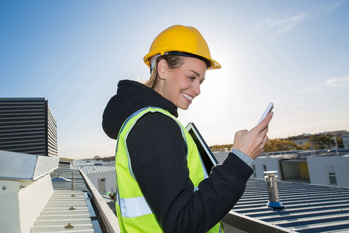 Female construction worker using phone