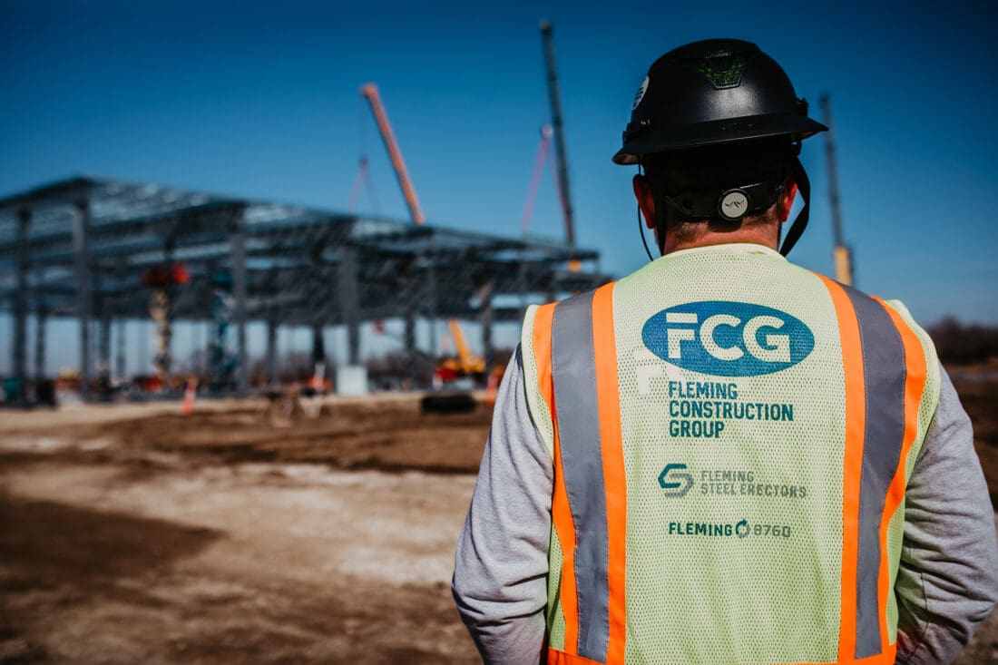 Construction worker on jobsite wearing FCG safety vest