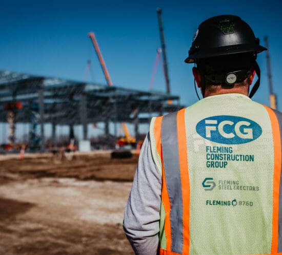 Construction worker on jobsite wearing FCG safety vest